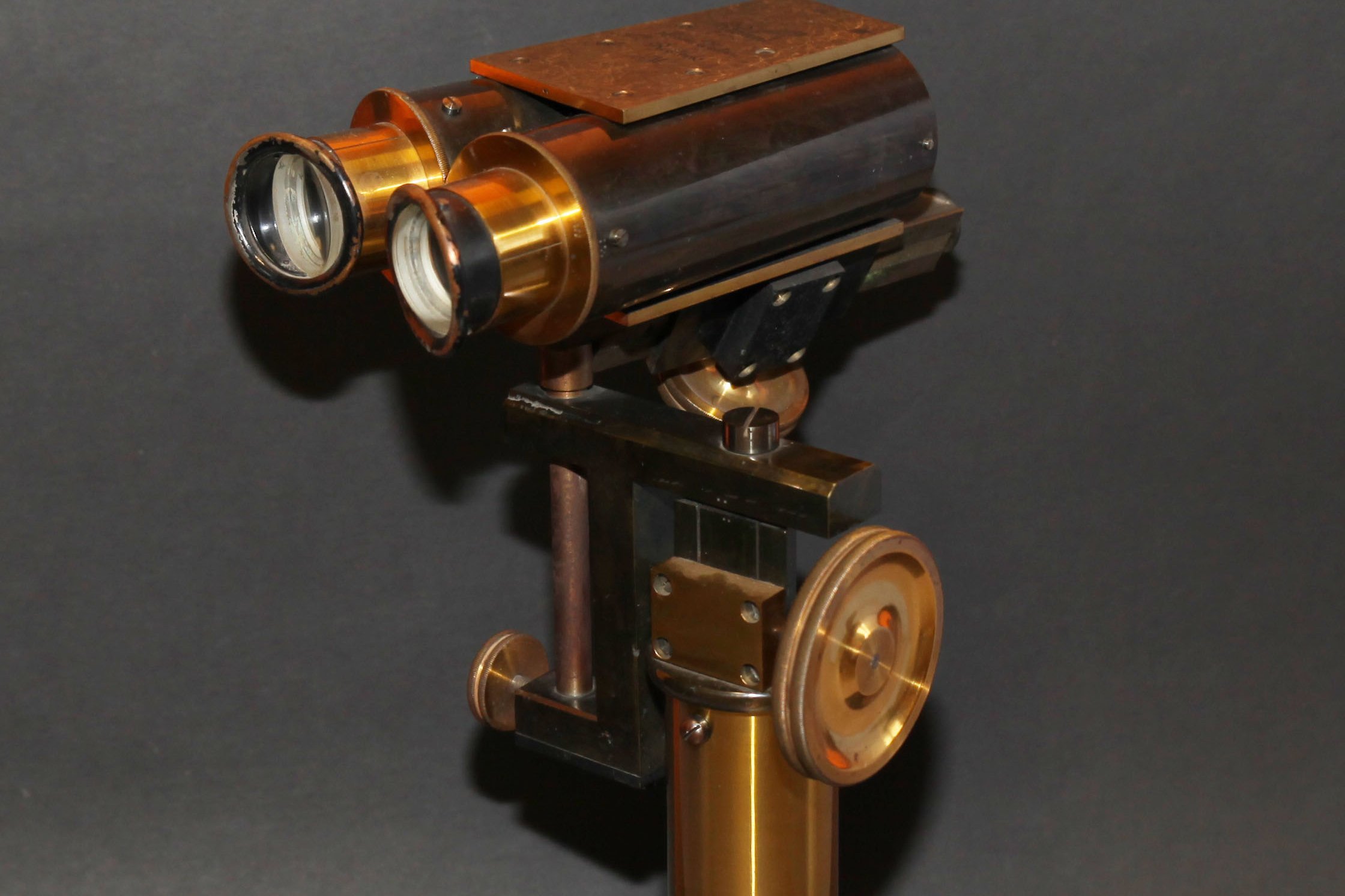 Golden metal instrument with a binocular-like attachment on top