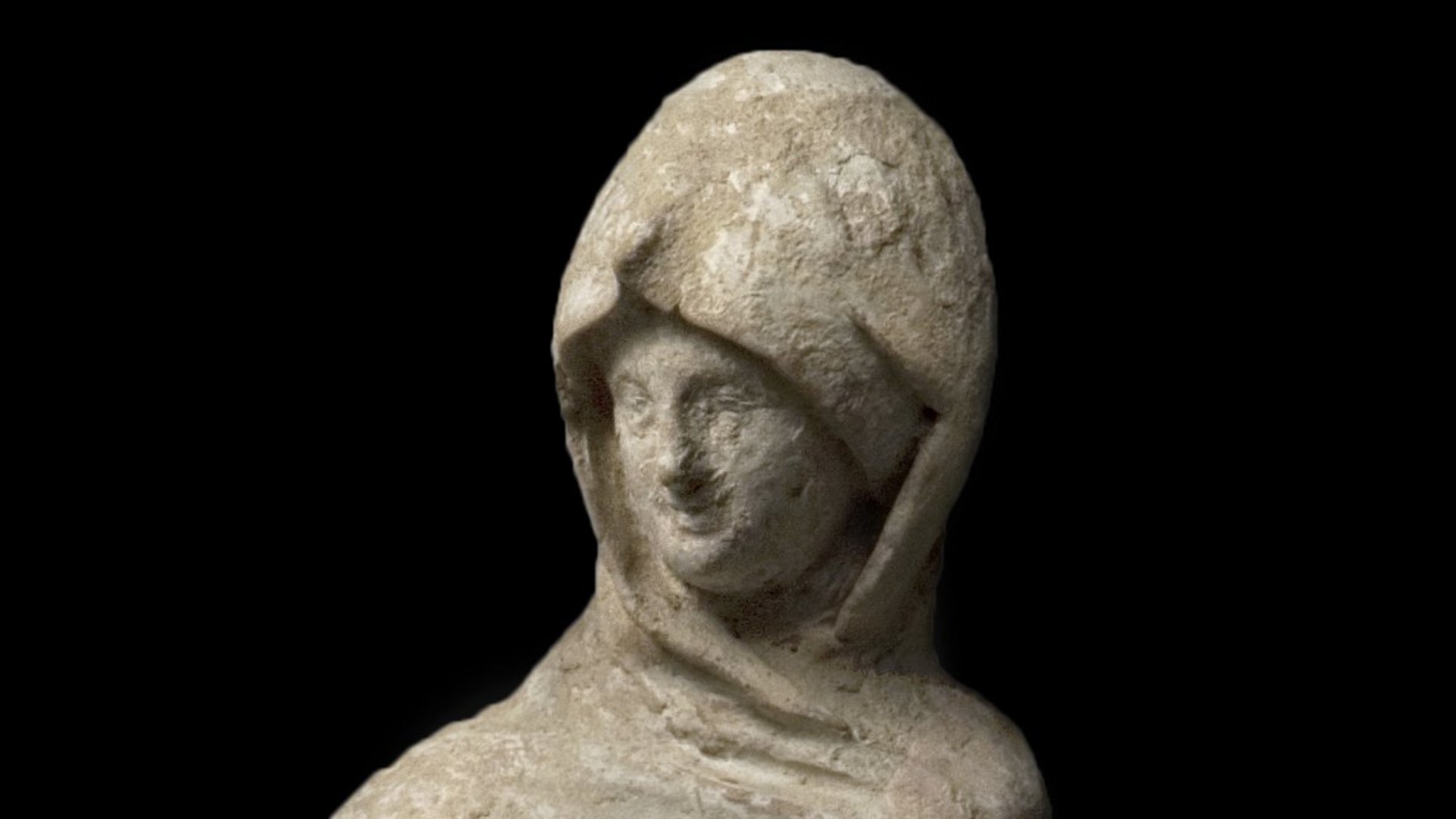 Photo: MUT Female robed figure, the cloak pulled over her head and one hand put into the cloak; the other holds a fan or mirror