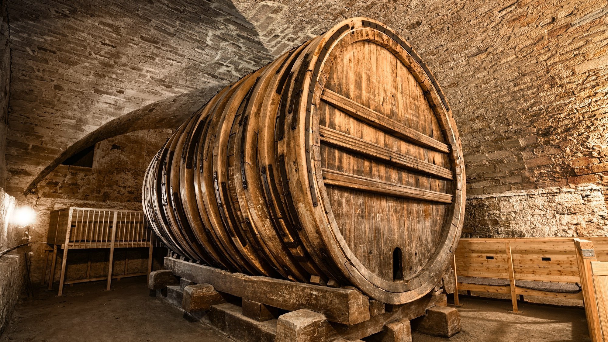 Giant wine barrel within the stone arches of Hohentübingen Castle's cellar