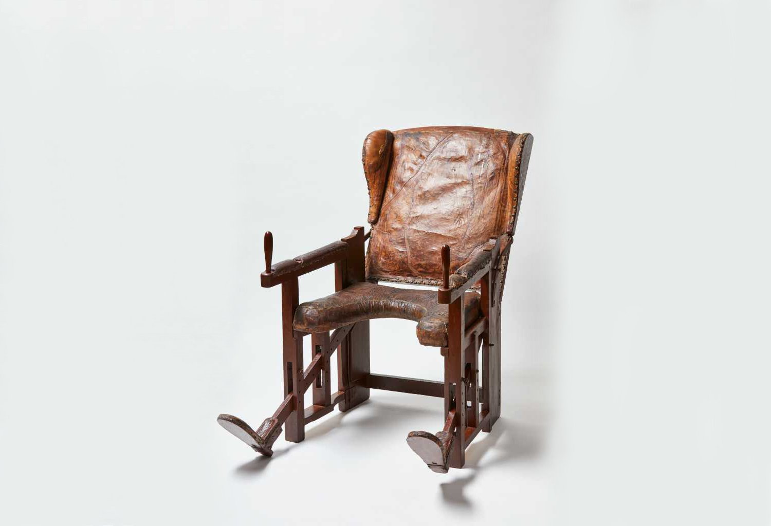 Restored wooden birth chair with embossed leather upholstery