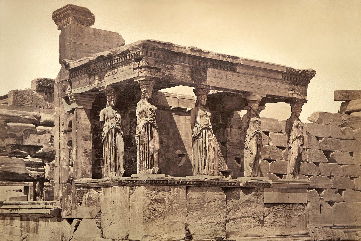 Photo: MUT a sepia-toned photo of the ruins of an open hall with female statues as columns